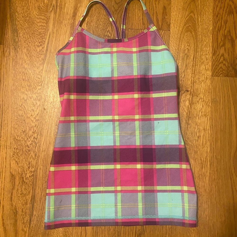 An Ivivva pink, green, blue, and purple tank top with built in bra. no stains